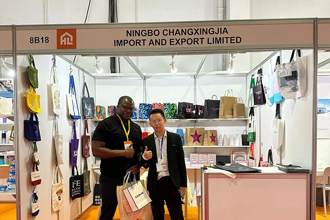Visitor carrying paper bag samples at our trade fair booth